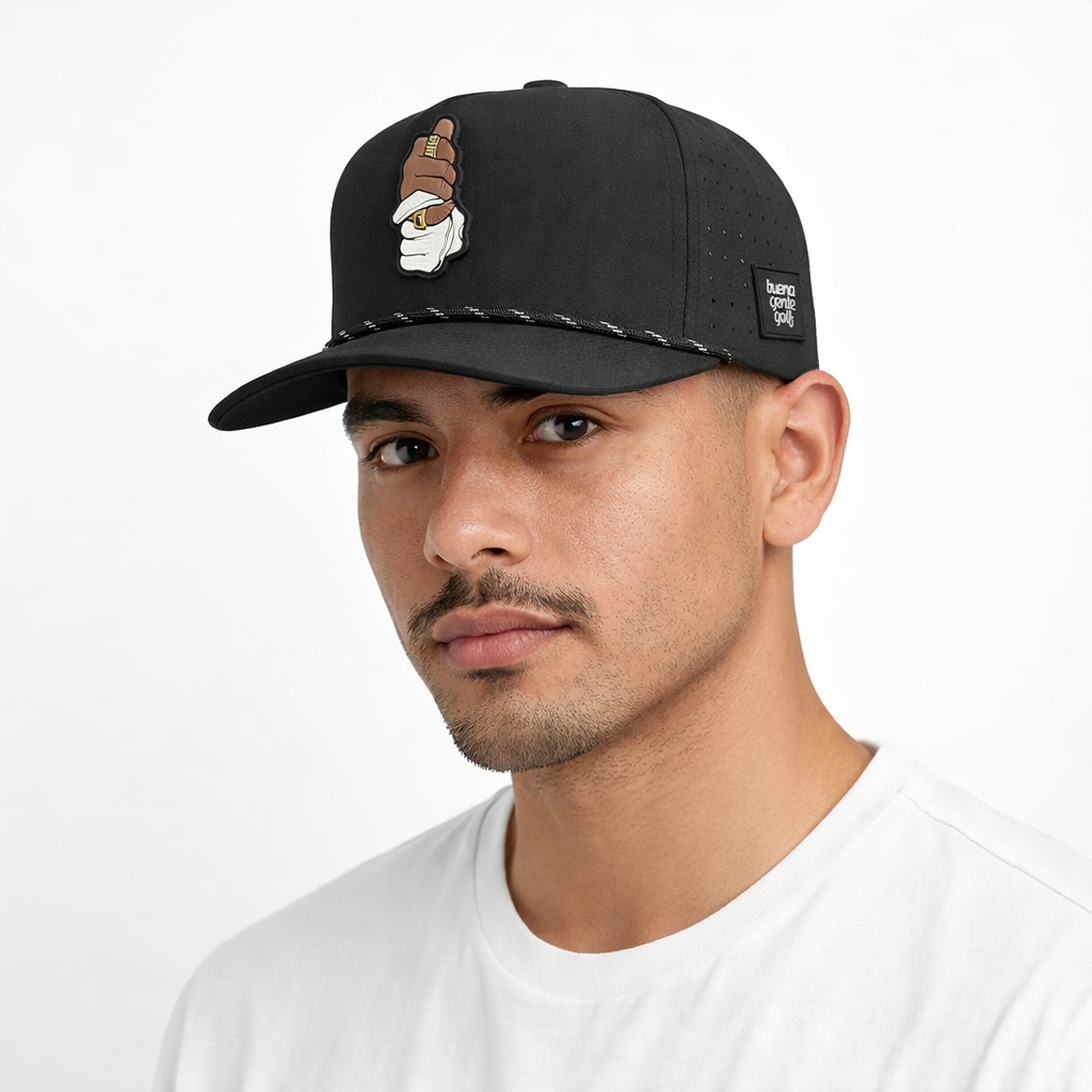 Man wearing a black buena gente cap on a white background