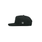 Grip snapback golf hat in black, side view